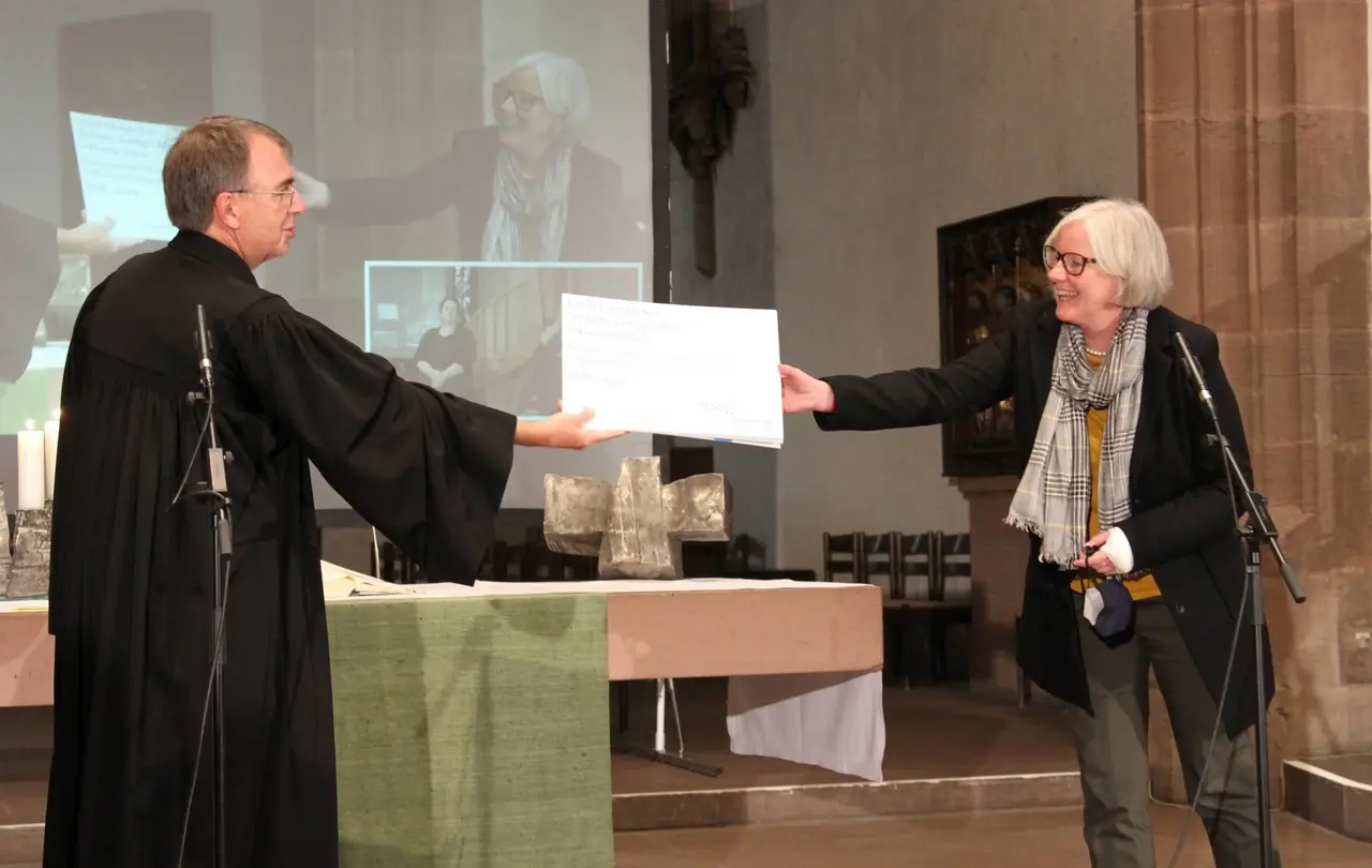 Dieter Kaufmann übergibt Botschaften aus dem Projekt an Sabine Foth, Präsidentin der Landessynode. 